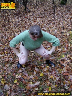 Pissing outdoor on dried leaves on a ground