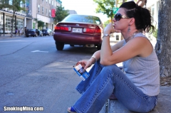 Brunette babe smoking while loitering on the street - N