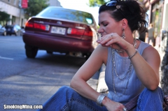 Brunette babe smoking while loitering on the street - N