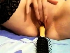 hot-babe-dildoing-her-pussy-with-hairbrush